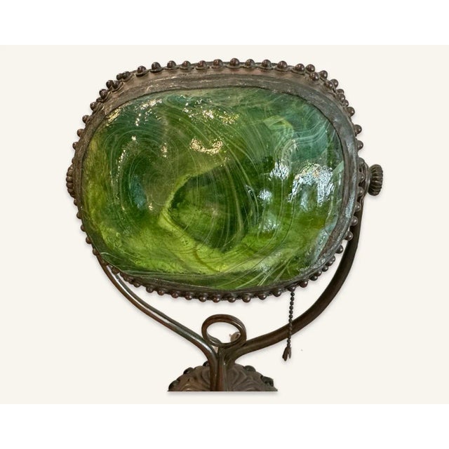 This Tiffany lamp, marked Tiffany Studios, New York, is an example of the “turtle back” glass designs of 1900. While most...