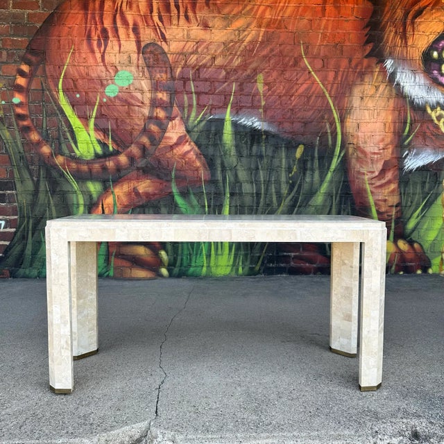 Maitland-smith tessellated marble console table This consult table features tessellated marble throughout with brass inlay...