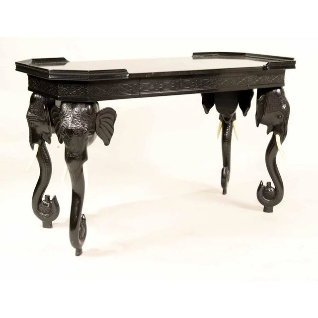 Exquisite table features detailed hand carved elephant head and legs. Single hidden drawer on one side and Arabesque...