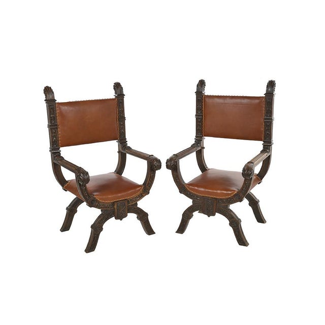 Pair of Italian renaissance style armchairs in carved wood. This piece is designed in the style of the selected designer...