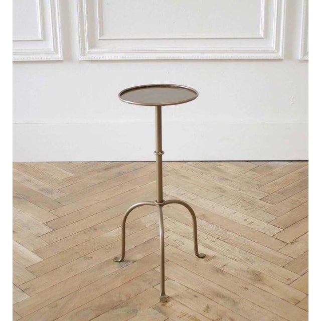 Cannes small iron drink table in brass finish. Inspired by the antique version, this small drink table is forged iron with...