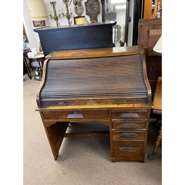 For sale is an antique roll top desk from the early 1900's. The top is an accordion style roll top also fully made of...