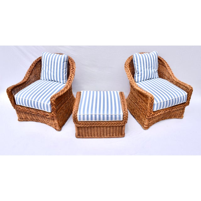 An exquisite Italian Wicker Works braided rattan set featuring two lounge chairs, and ottoman with new custom cushions,...