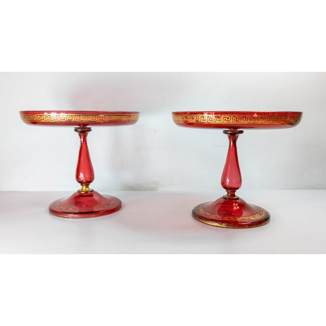 We are selling this gorgeous pair of Bohemian glass compotes. These Cranberry Red glass compotes have great neoclassical...