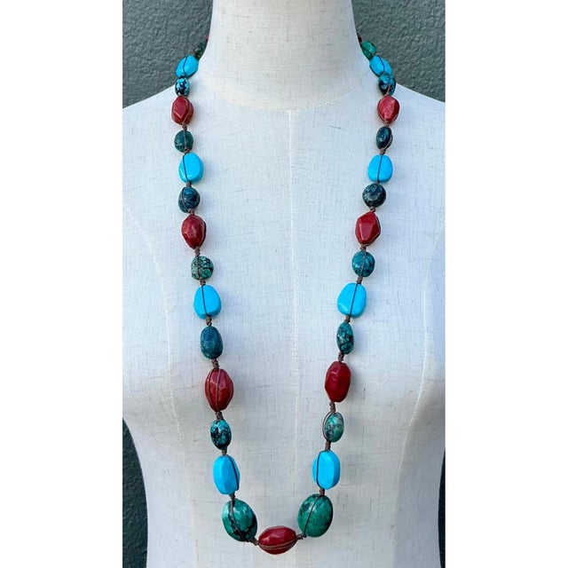 This captivating vintage turquoise and coral bead necklace presents an exceptional handcrafted composition, expertly...