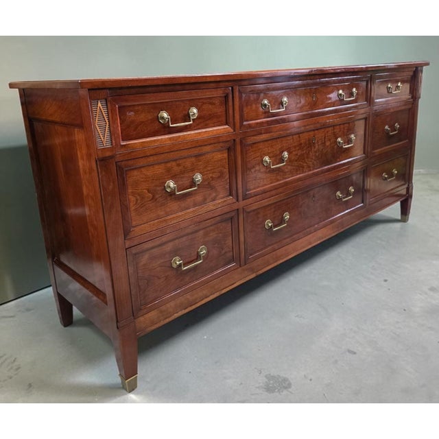 Crafted by Stickley, this handsome traditional triple dresser showcases exceptional American craftsmanship in solid cherry...