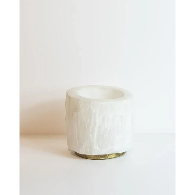 Snowy quartz statement candle holders, with a brass stand. Due to the natural handcrafted materials used, variation in...