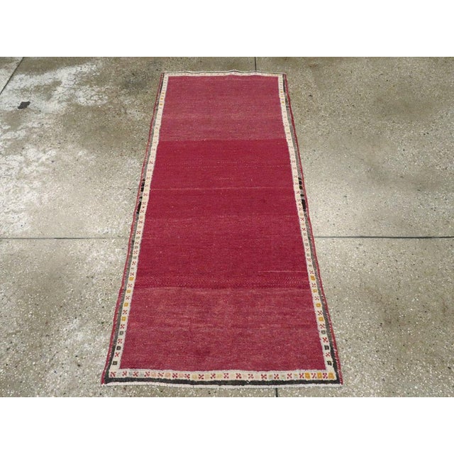 A vintage Turkish Anatolian throw rug. A string-like ivory border makes a simple frame for the well-abrashed totally plain...