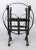 A charming French country black wrought iron magazine rack with stylized scrolls and lovely old paint and patina. It's...