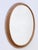 Highly decorative and rare mid-century modern oval wall mirror. manufactured in germany, 1960s. executed in rattan and...
