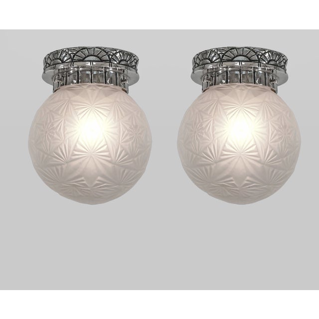 CÉLESTIN JAMAIN & SONOVER A pair of French art deco flush mounts in nickel-plated bronze or solid brass, crafted circa...