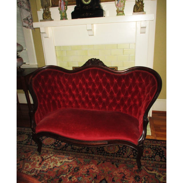 This is a Gorgeous! Antique Victorian Hand Carved Walnut Love Seat that is in Red Velvet with a Deep Tufted Back with a...