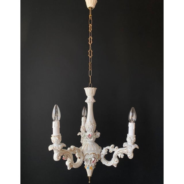 The chandelier is made of porcelain. It is adorned with beautiful mouldings and hand-painted details. A luxurious and...