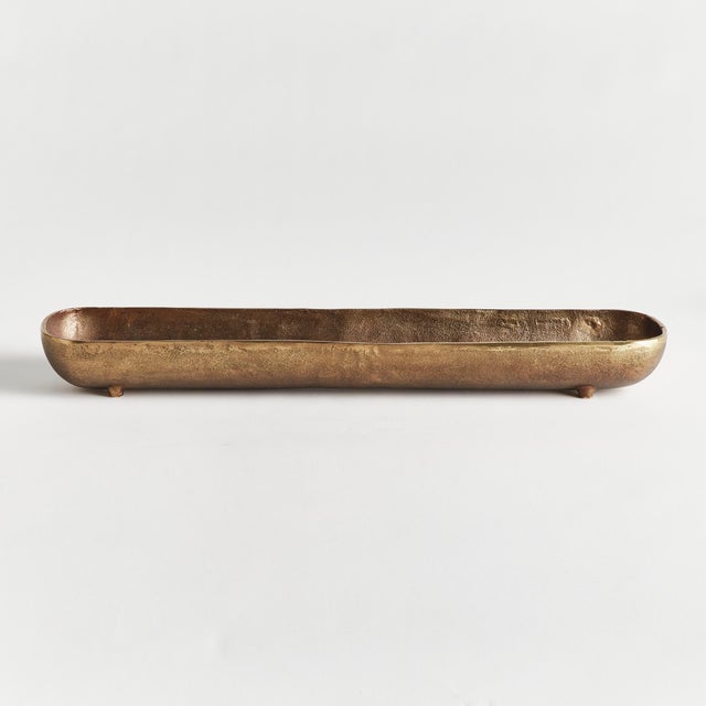 A narrow, slender form and simple design make this cast aluminum tray unique. Line with a collection of candles, or...