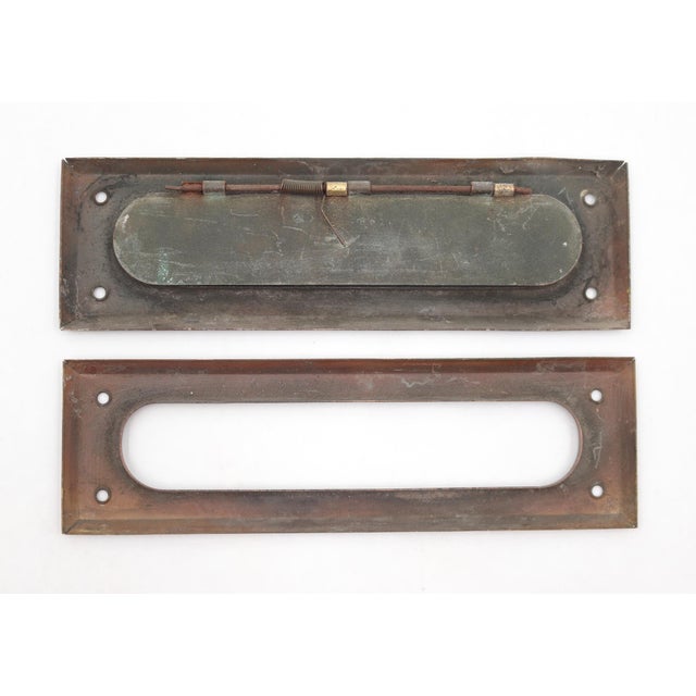 Vintage spring loaded mail slot that opens inward at 45 degrees to allow mail through. Made of pressed brass with a patina...