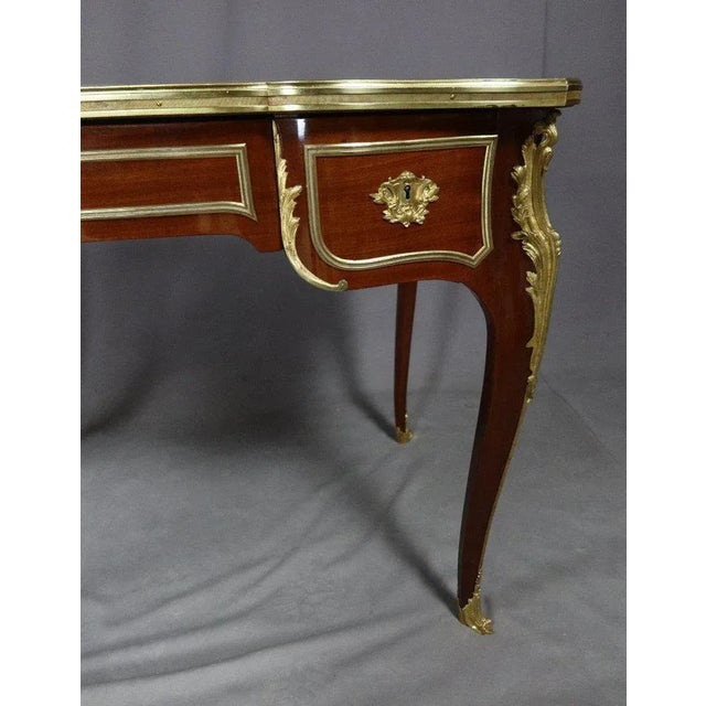 "Bureau Louis XV" Charming small mahogany office and bronze in Louis XV style entirely restored. It opens with three...