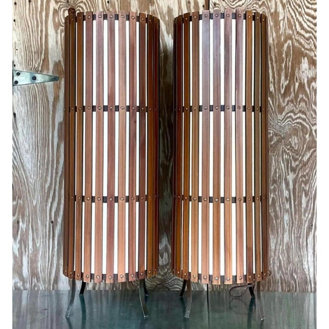 Striking pair of vintage mid-century modern floor lamps featuring tall cylindrical shades constructed from warm wood slats...