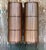 Striking pair of vintage mid-century modern floor lamps featuring tall cylindrical shades constructed from warm wood slats...