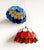 Pair of Tiffany-style Art Deco pendant lights, spherical with scalloped edges. One is made of colored glass paste, beige...