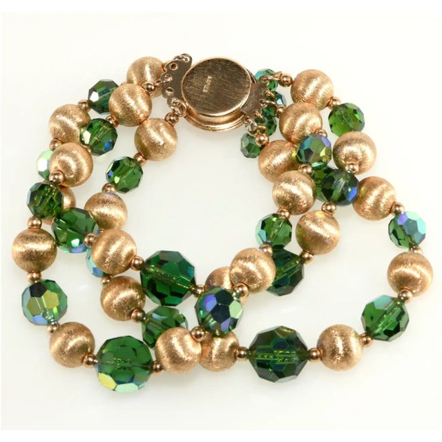 This is part of Chairish’s Costume Jewelry assortment. Bracelet made with green faceted beads with iridescent finish and...