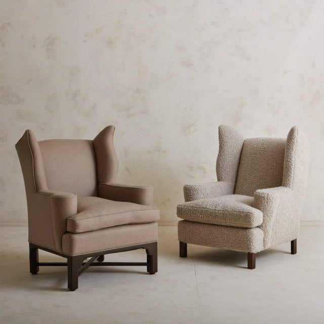 An antique German wingback lounge chair freshly upholstered in a taupe wool-blend fabric with a subtle striped detail and...