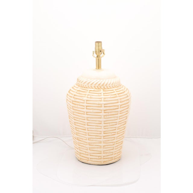 A large pair of faux bamboo basket weave ceramic lamps that are neutral in color to work in a variety of spaces. They have...