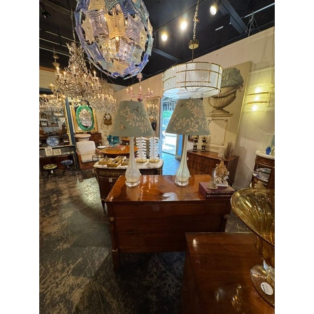 The Pair of Murano Opal Glass Lamps with Gracie Shades are luxurious and elegant lighting fixtures. Each lamp features a...