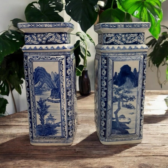 A pair of tall Chinese Blue and White Porcelain Vases with markings on the bottom. Hand painted scenery on 4 panels. Each...