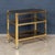 A refined French drinks trolley attributed to Maison Jansen, dating from the 1970s, featuring a gilt brass frame with...