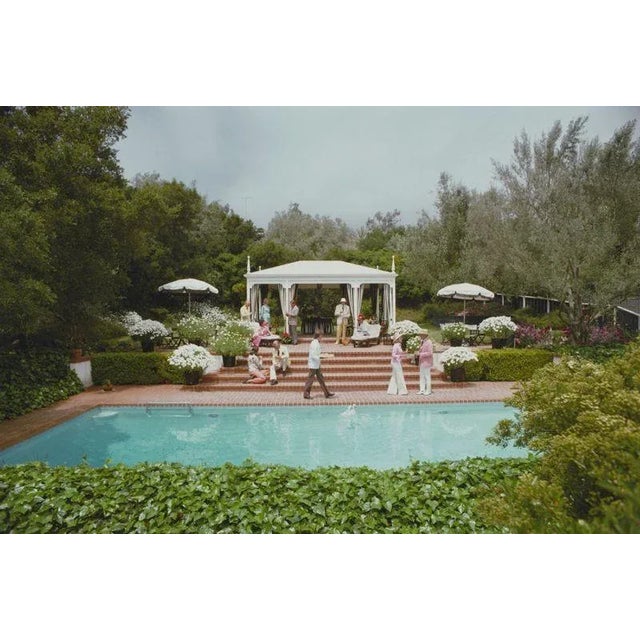 Poolside Drinks 1961 Guests around the pool at Dorothy Laughlin’s Santa Barbara home. Slim Aarons Slim Aarons was one of...