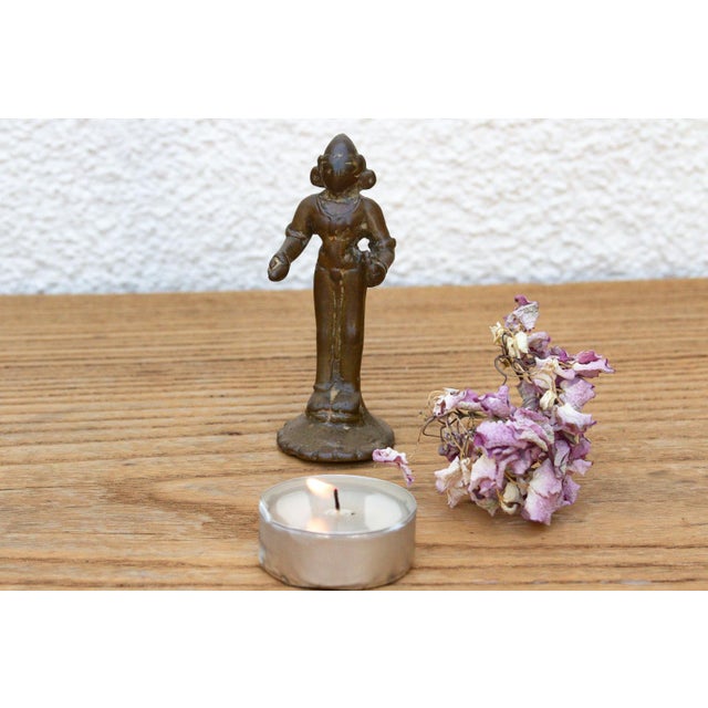 A beautifully cast micro-scale devotional figurine depicting a standing celestial attendant or deity, finished in a...