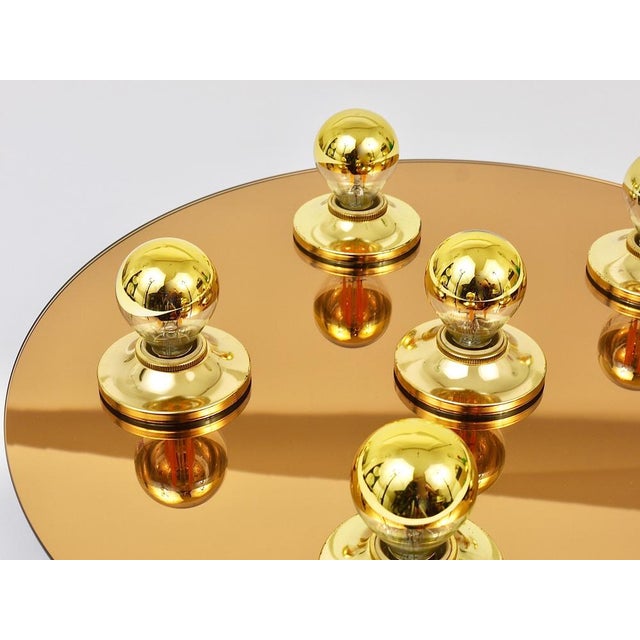 A Italian round lamp from the 1970s, to be used as a wall light / sconce or flush mount / ceiling light. Made of bronze...