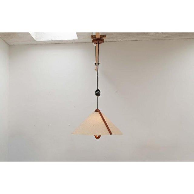 This teak and fabric ceiling lamp ‘winga’ was designed and produced by domus in germany during the 1970’s. The height of...