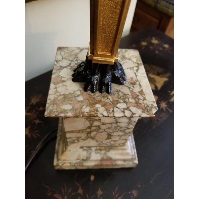 Highly decorative bronze lamp in gold and black with a marble base. This was a mythological character face. ...and there...