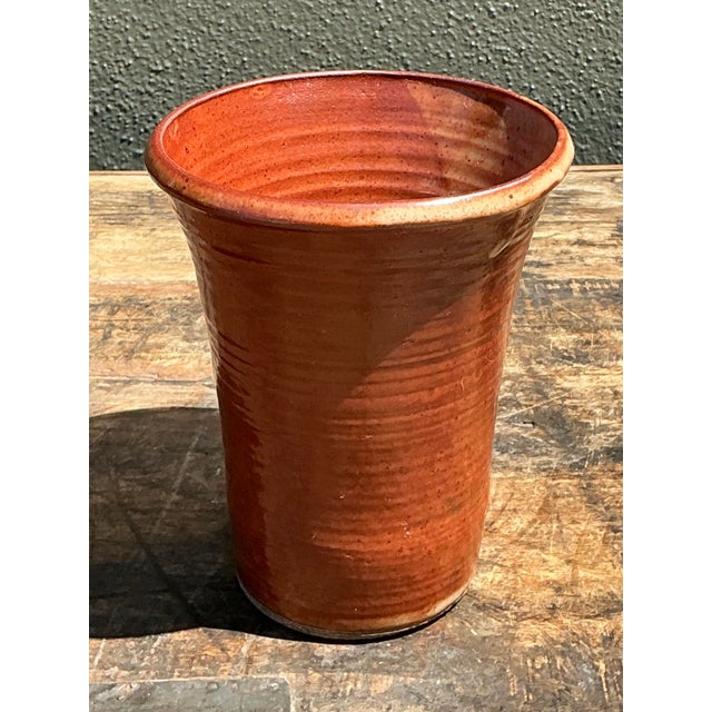 This charming vintage studio pottery vase showcases a beautiful fusion of rustic texture and warm, earthy tones. Hand-...
