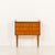 This small teak dresser was made in Denmark in the 1960s. It features three drawers with integrated solid teak sculptural...