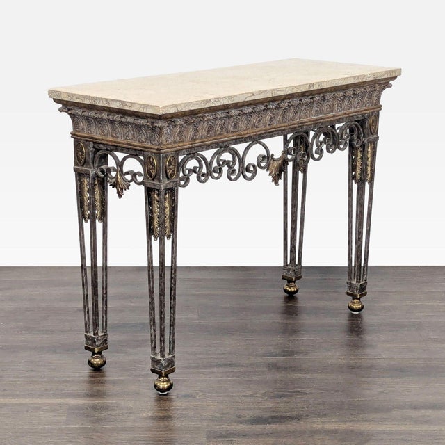 Marble top table with iron base and brass embellishments. Brand: Maitland-Smith. Dimensions (in): 48W x 19D x 36H.