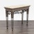 Marble top table with iron base and brass embellishments. Brand: Maitland-Smith. Dimensions (in): 48W x 19D x 36H.