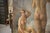 This painting has been restored several times. It is a figurative oil on canvas depicting two female nudes, one seated...