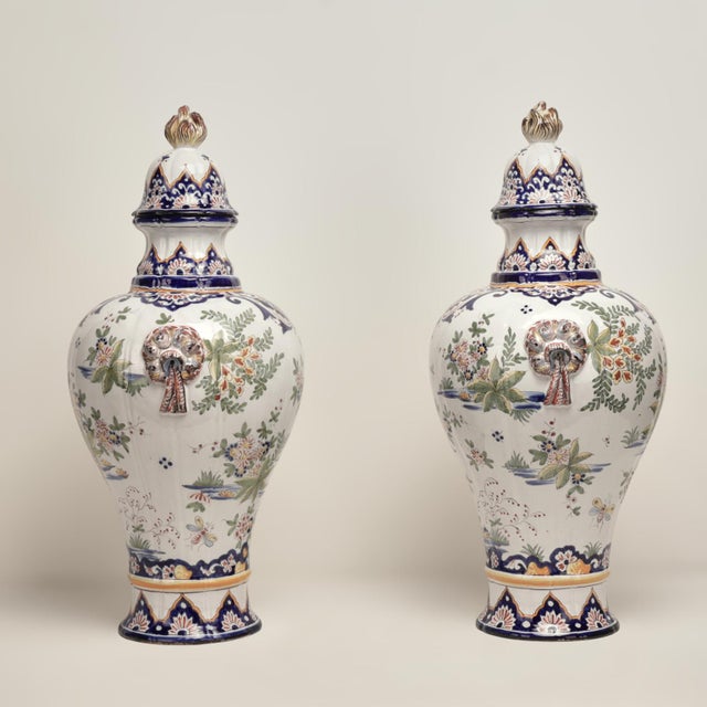 Standout pair of large 19th century French faience earthenware lidded urns handcrafted in classic form featuring tassel...