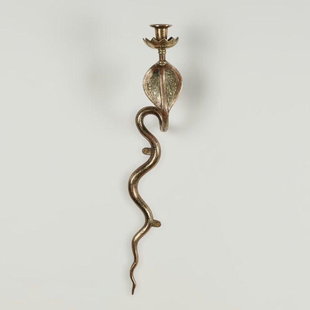 Standout pair of vintage Anglo Indian wall sconces crafted in brass in a stylized cobra snake form and decorated with red...