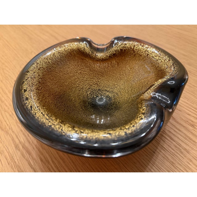 This 1970's Murano-style brown and gold glass bowl measures approximately 7" x 6.5" X 3". It retails for approximately...