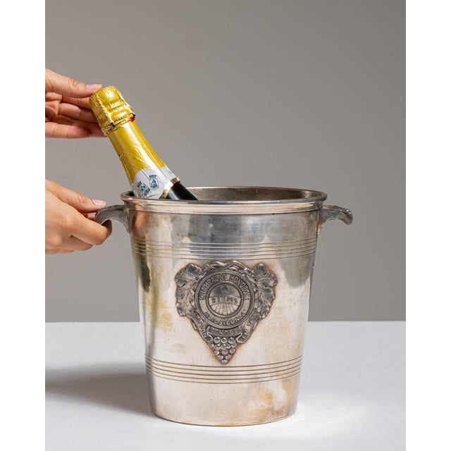 This mid 20th century ice bucket from France is finished in gold, worked in silver. It is fitted with a heart-shaped...