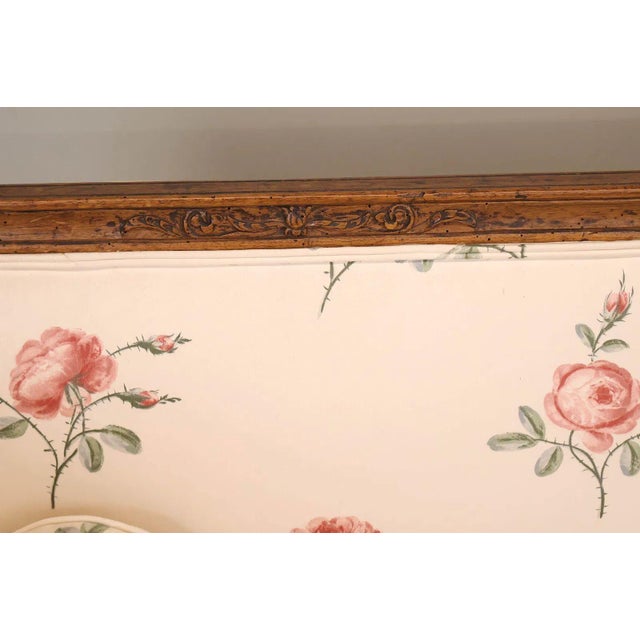 This 19th Century French settee is crafted in the Louis XVI taste, showcasing a beautifully carved walnut frame with...