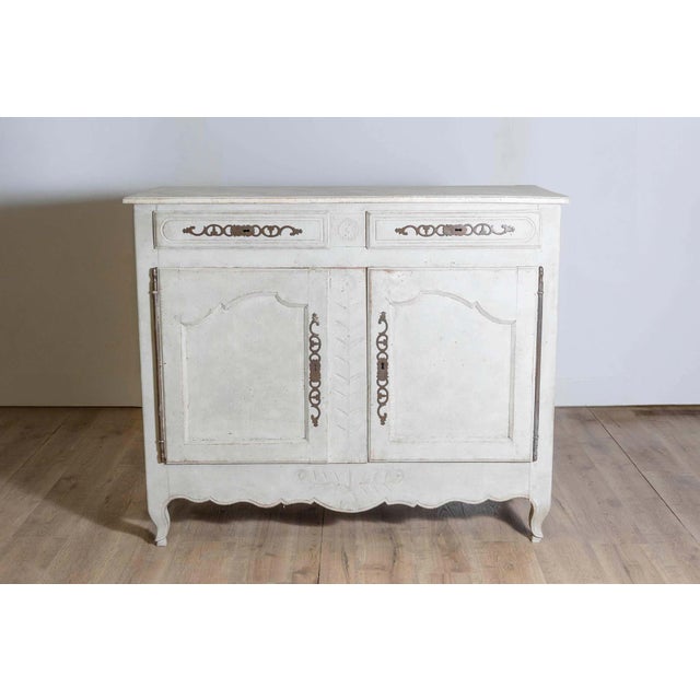 A French Louis XV period painted wood buffet from the mid-18th century, with two drawers over two doors and scalloped...