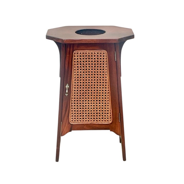 A beautiful tapered form and designed 1 door cabinet. In the style of L&JG Stickley or Limberts. Mahogany with cane inset...