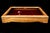 A vintage tabletop collector's display case in a burl wood frame in warm amber tones, gilt glazed lid, red felt-lined...