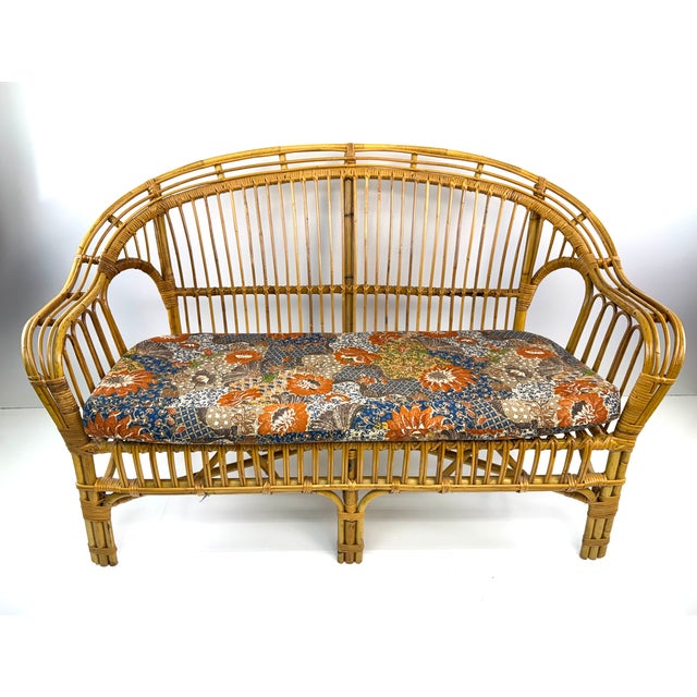 Crafted by O-Asian Designs of California in 1975, this vintage three-piece rattan living room set embodies the relaxed...