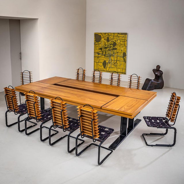 Large, architecturally composed conference table accompanied by ten sculptural chairs made of beechwood with black metal...