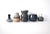 A collection of 5 pottery vessels by various artists, including a 5.6" triple-tier blue vase, a 4.5" speckled and striated...